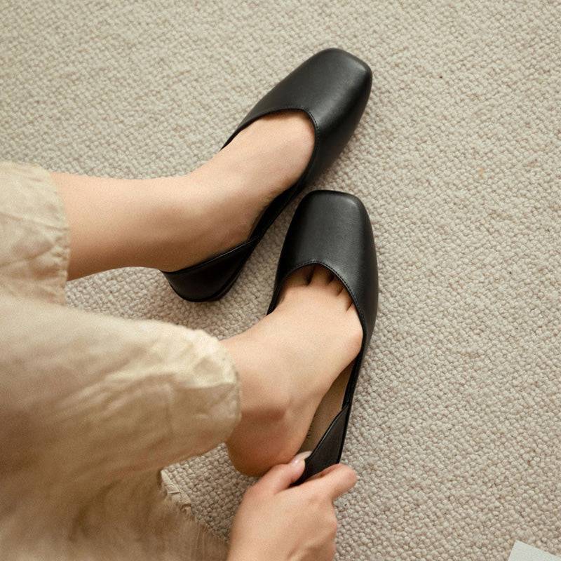A pair of black leather square-toe flat shoes