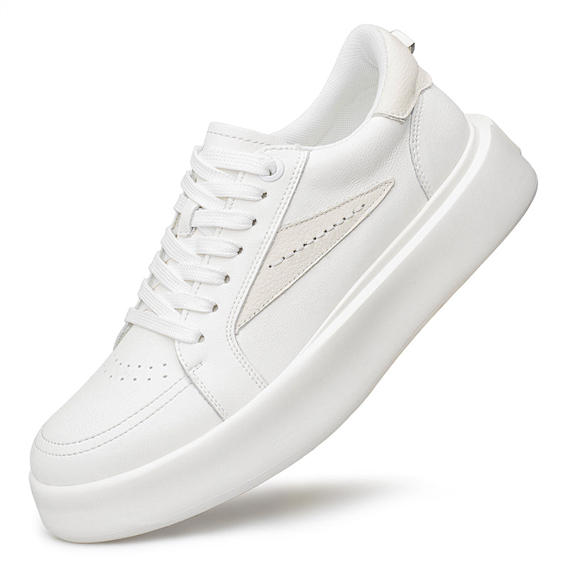 White thick-soled platform sneaker captured in a dynamic pose
