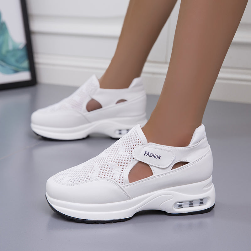 Model wearing white mesh fashion sneakers with a modern design